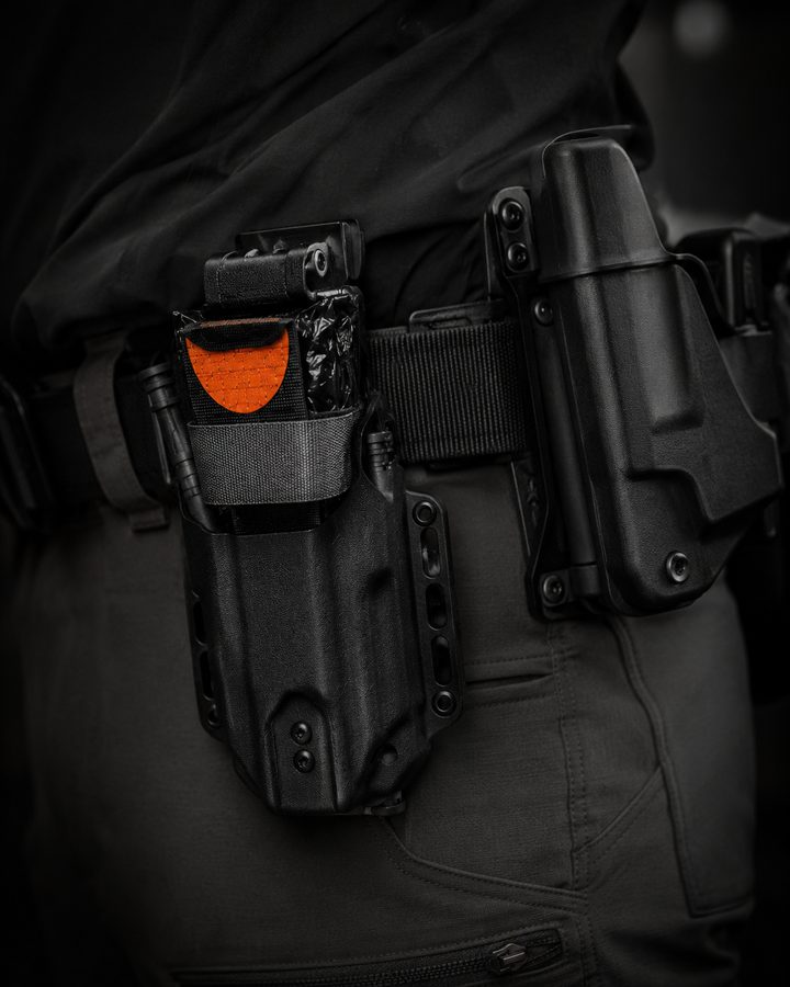 Kydex pouch mounted on belt next to holster